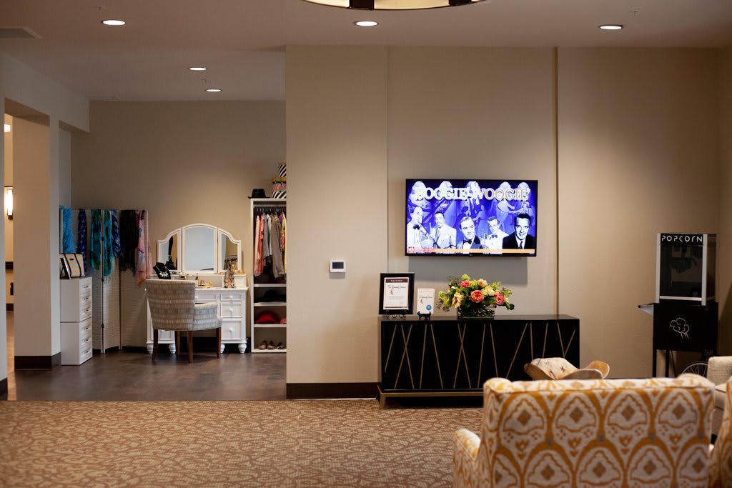 A cozy living room with a TV, vanity, and decorative elements.