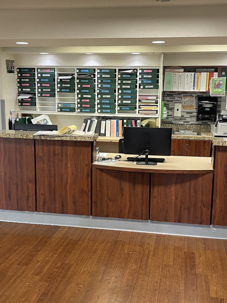 A reception desk with office equipment and organized workspace.