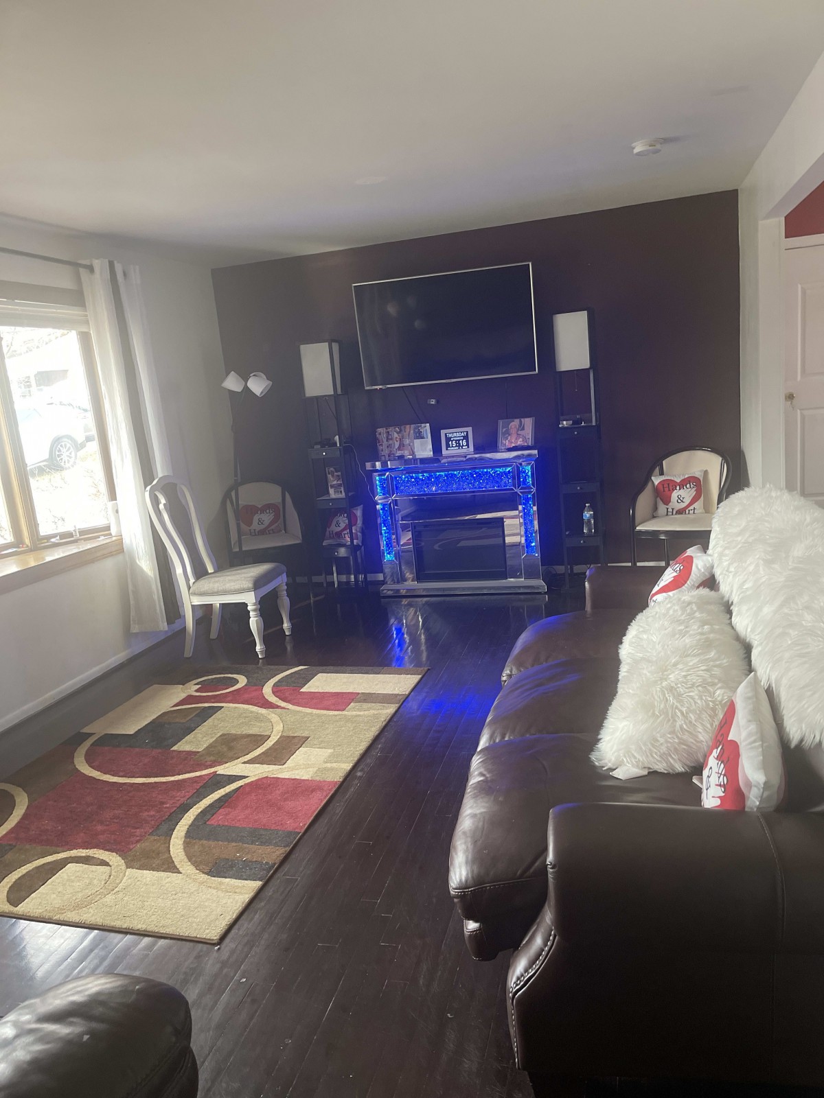 A cozy living room with a fireplace, television, and comfortable seating.