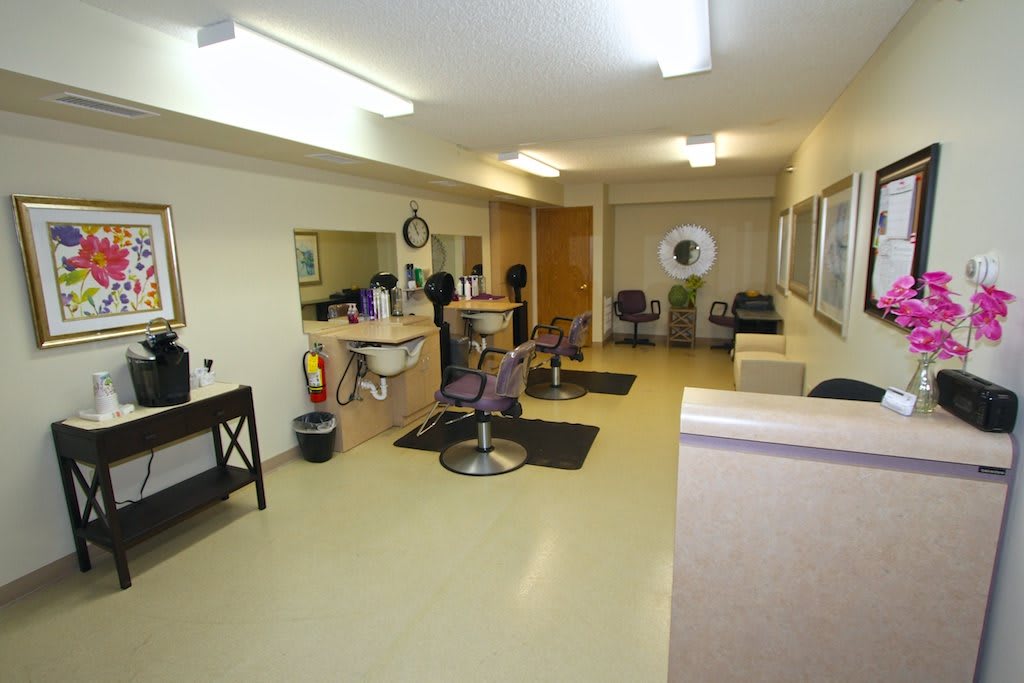 A spacious hair salon with multiple styling stations and mirrors.