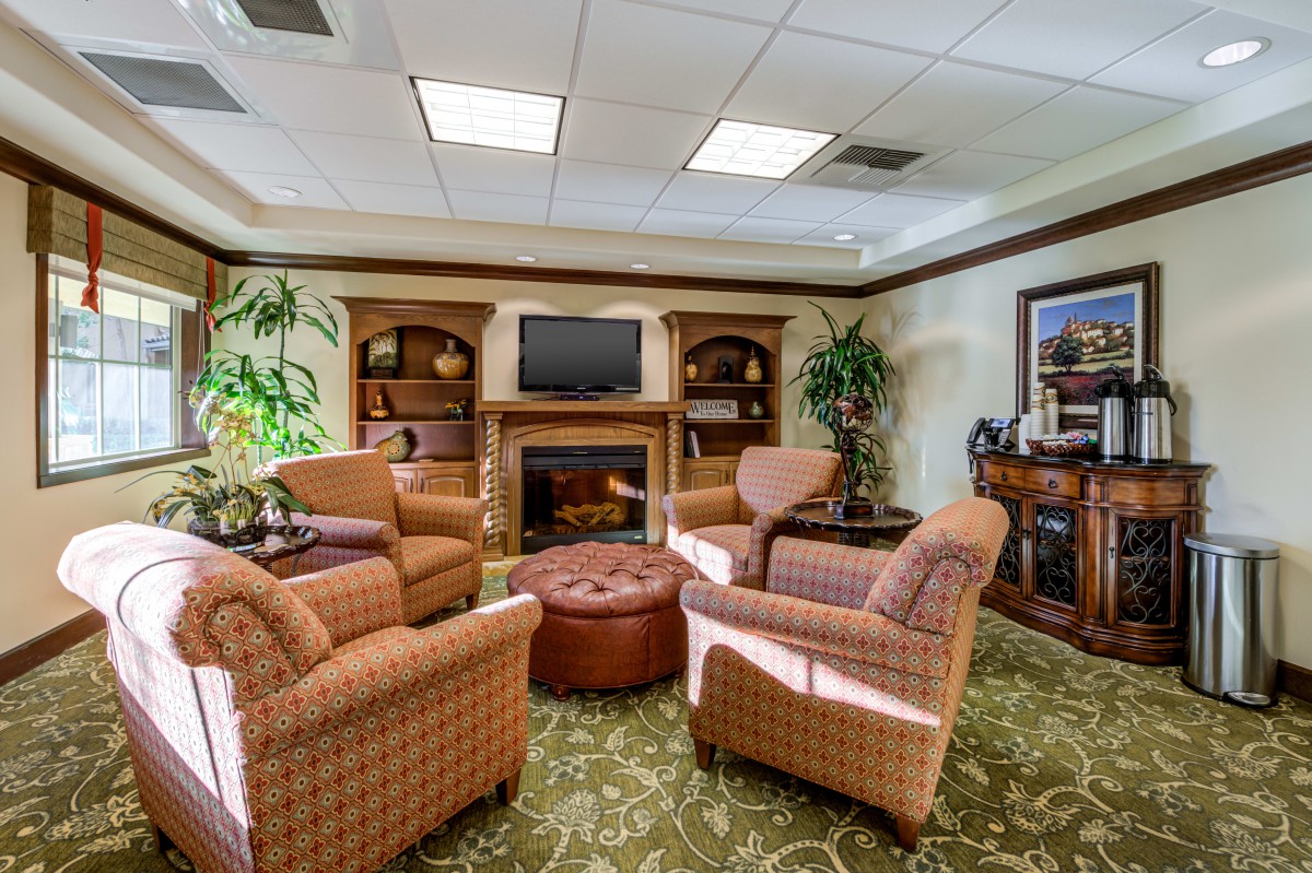 Cozy living room with comfortable chairs and a central TV.