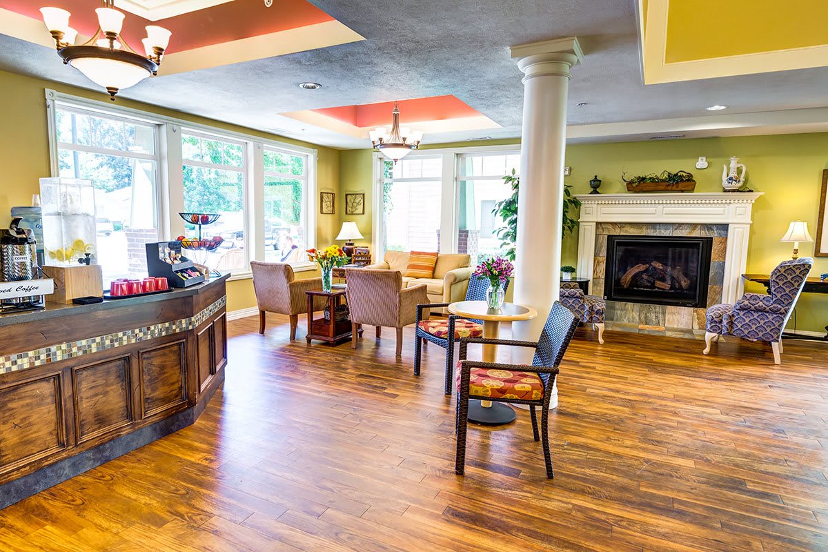 A brightly lit, modern living room with comfortable seating and a cozy fireplace.