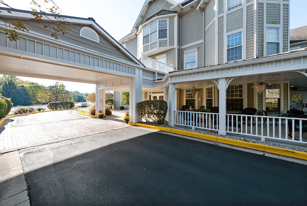 A hotel entrance with a covered driveway and stylish architecture.