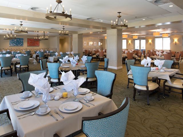 An elegant dining room with neatly arranged tables and chairs, featuring stylish interior design.