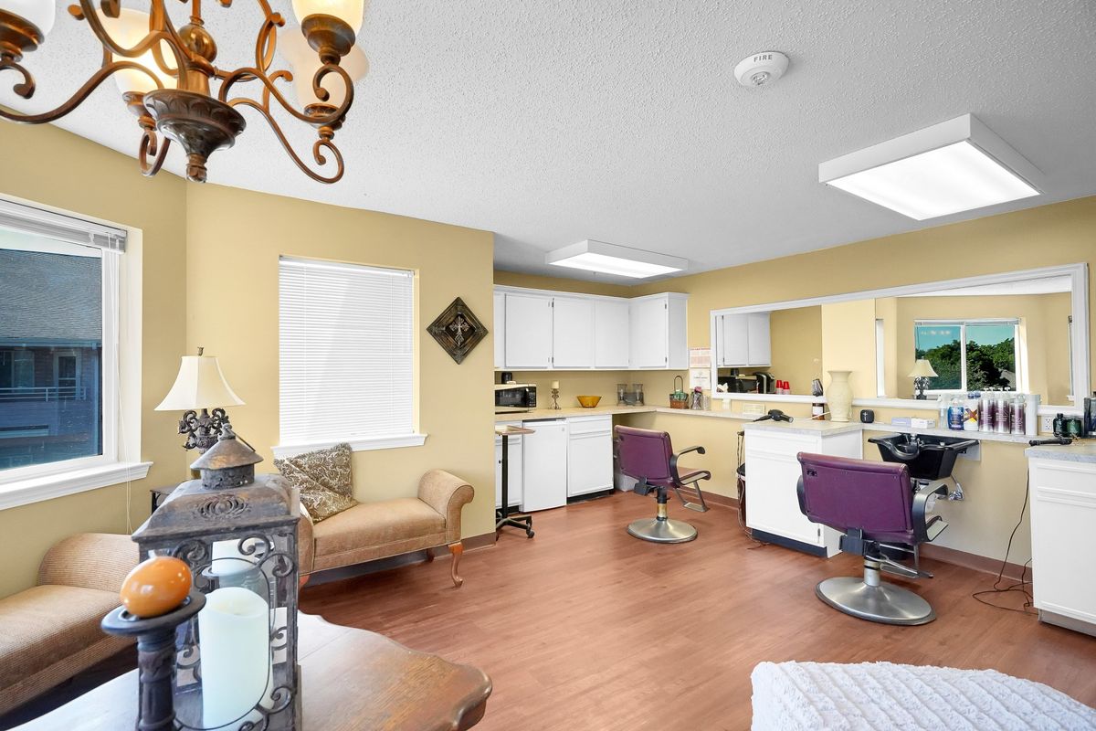 A well-lit salon interior featuring chairs, mirrors, and modern decor.