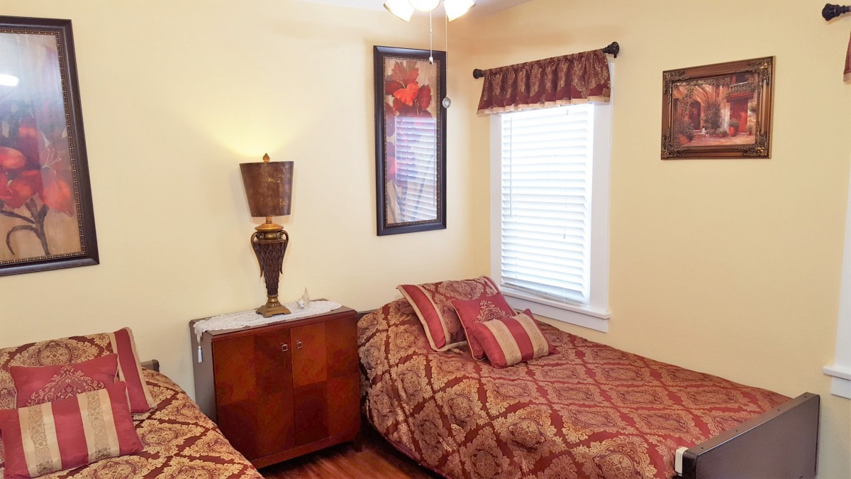 A cozy bedroom with twin beds and decorative elements.