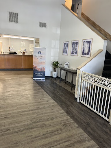 A welcoming lobby area featuring a reception desk and stairs, complemented by modern furnishings and decor.