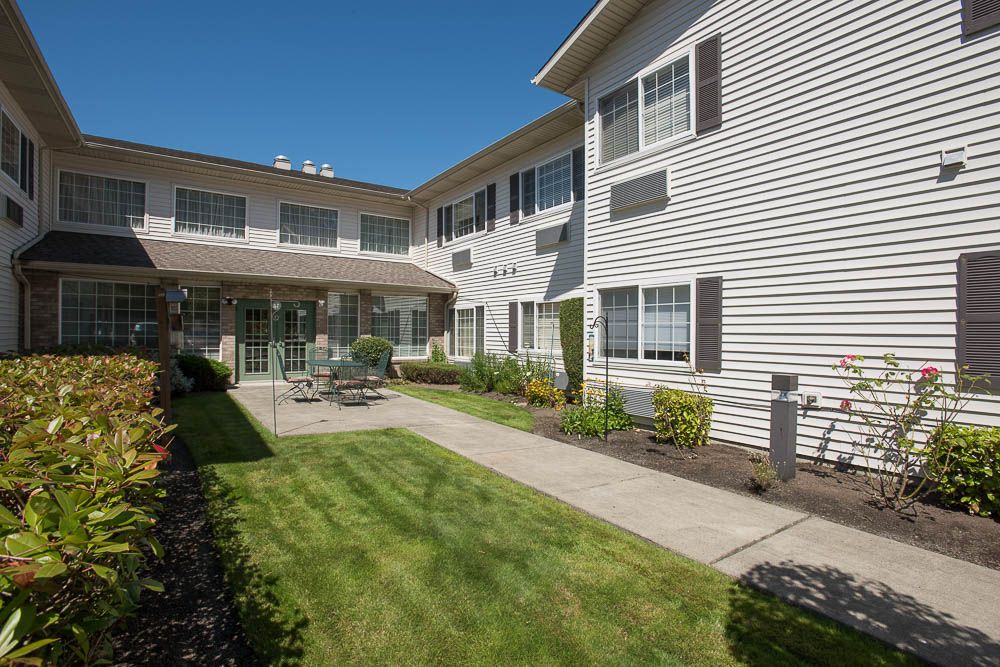 A well-maintained residential building with a neatly landscaped outdoor area.