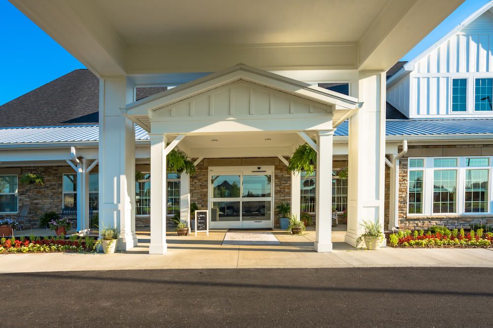 A covered entrance to a modern building on a sunny day.