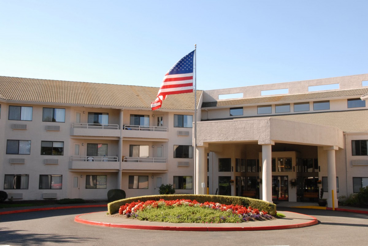A hotel entrance with an American flag prominently displayed.