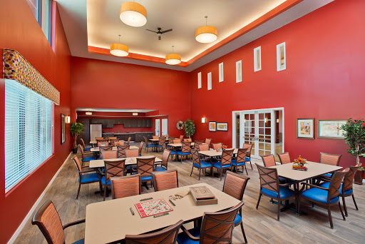 A vibrant dining area featuring red walls and comfortable seating.