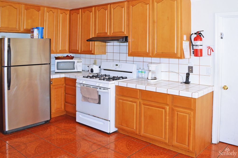 A modern kitchen with wooden cabinets and stainless steel appliances.
