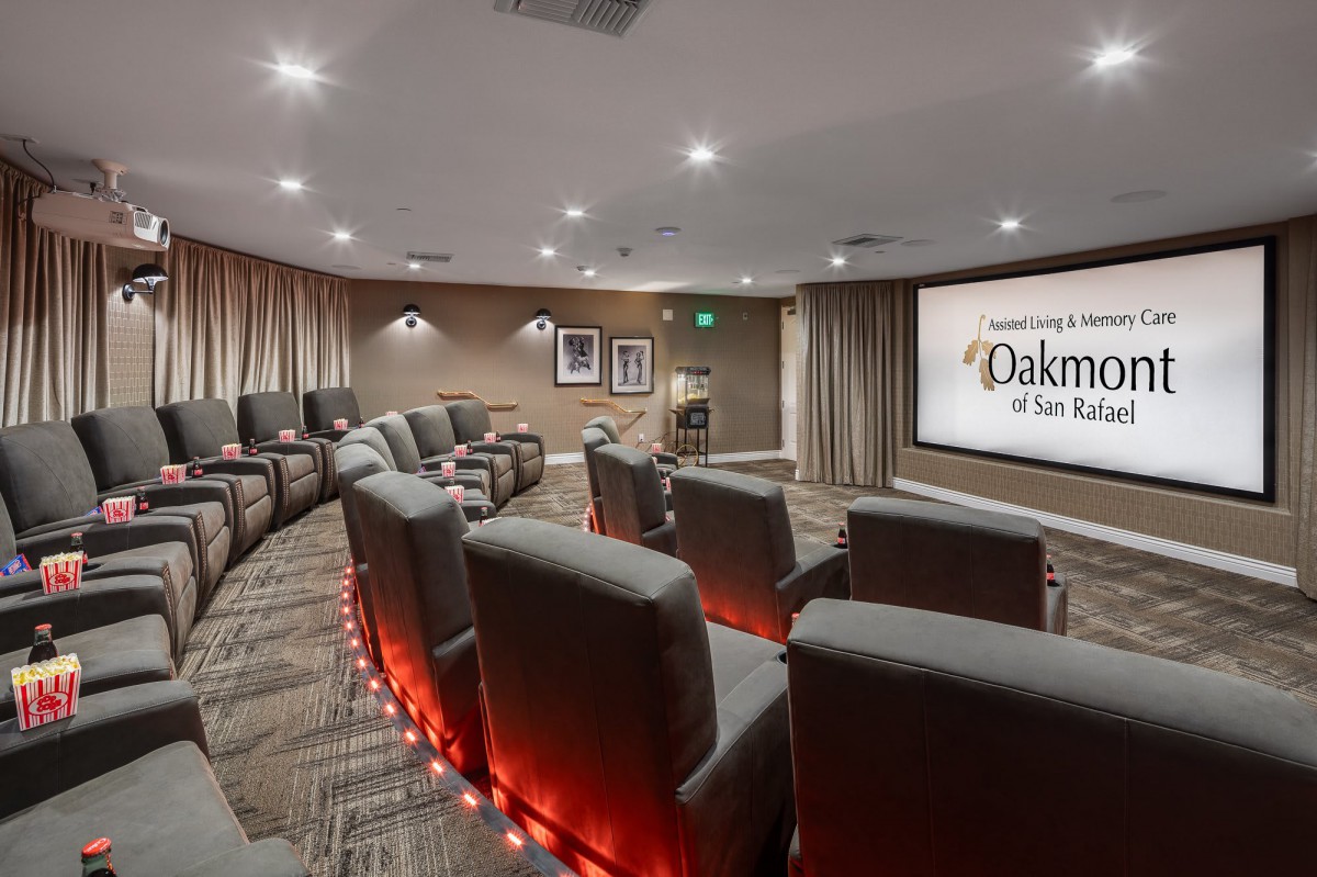 A cozy home theater with comfortable seating and a large screen for movie viewing.