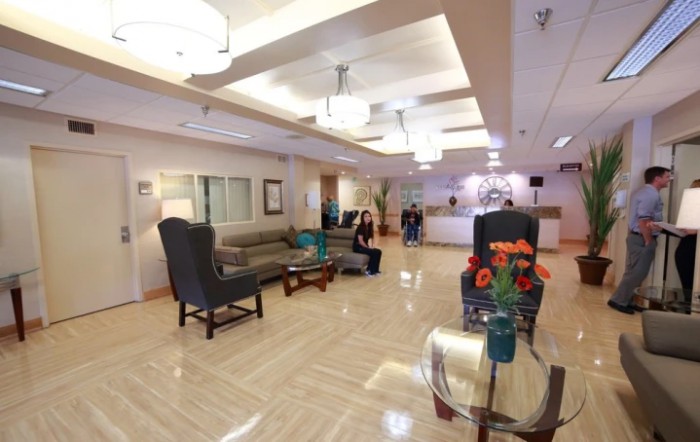 A spacious and modern lobby with comfortable seating and decorative elements.