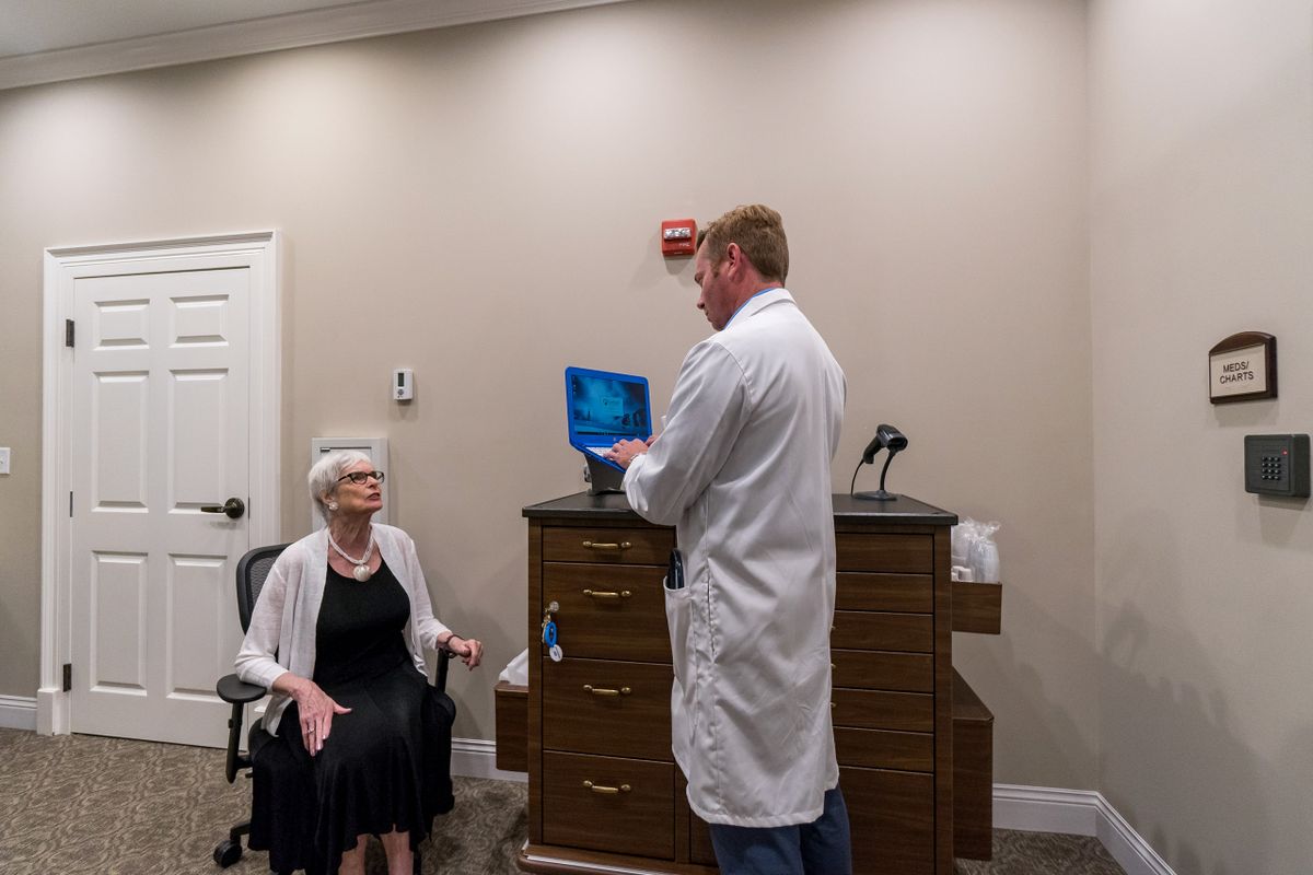 A doctor consults with a patient in a medical office setting.