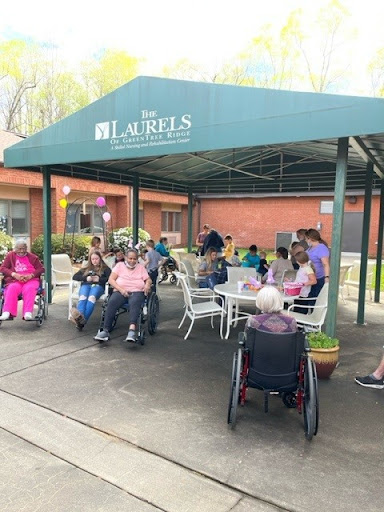 Residents enjoying a sunny day outdoors at the community center.
