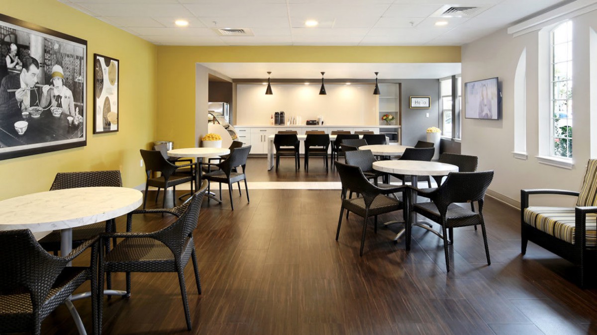A modern dining area with stylish furniture and lighting.