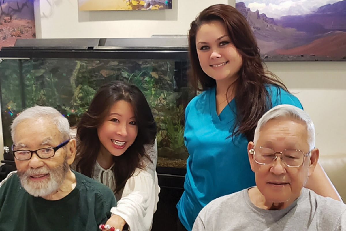 Group photo of healthcare workers and seniors smiling together.
