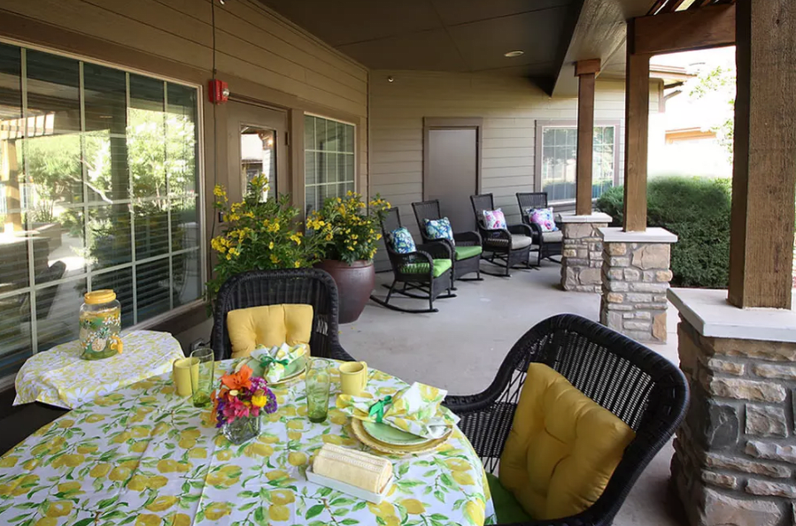Charming outdoor patio with a beautifully set table and cozy seating area.