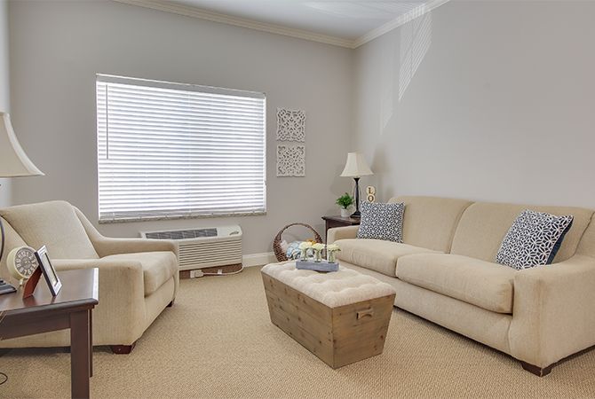 A cozy living room featuring neutral-toned furniture and decor.