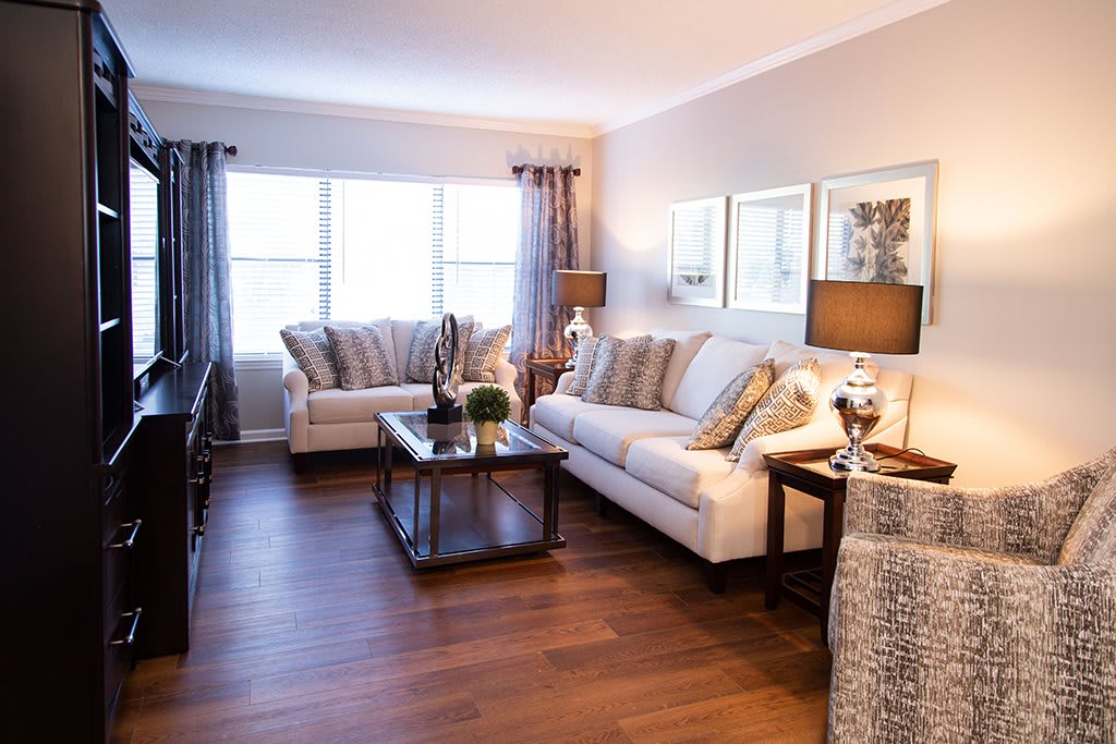 A cozy and stylish living room with comfortable seating, elegant decor, and natural light.