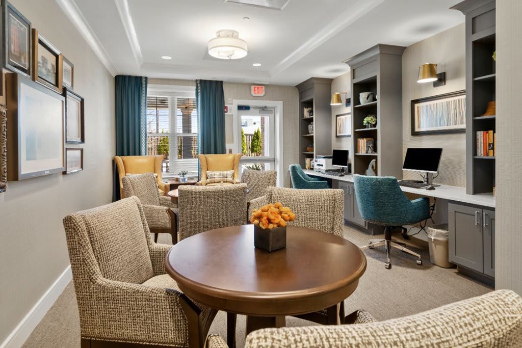 A modern lounge with comfortable seating, workstations, and stylish decor.