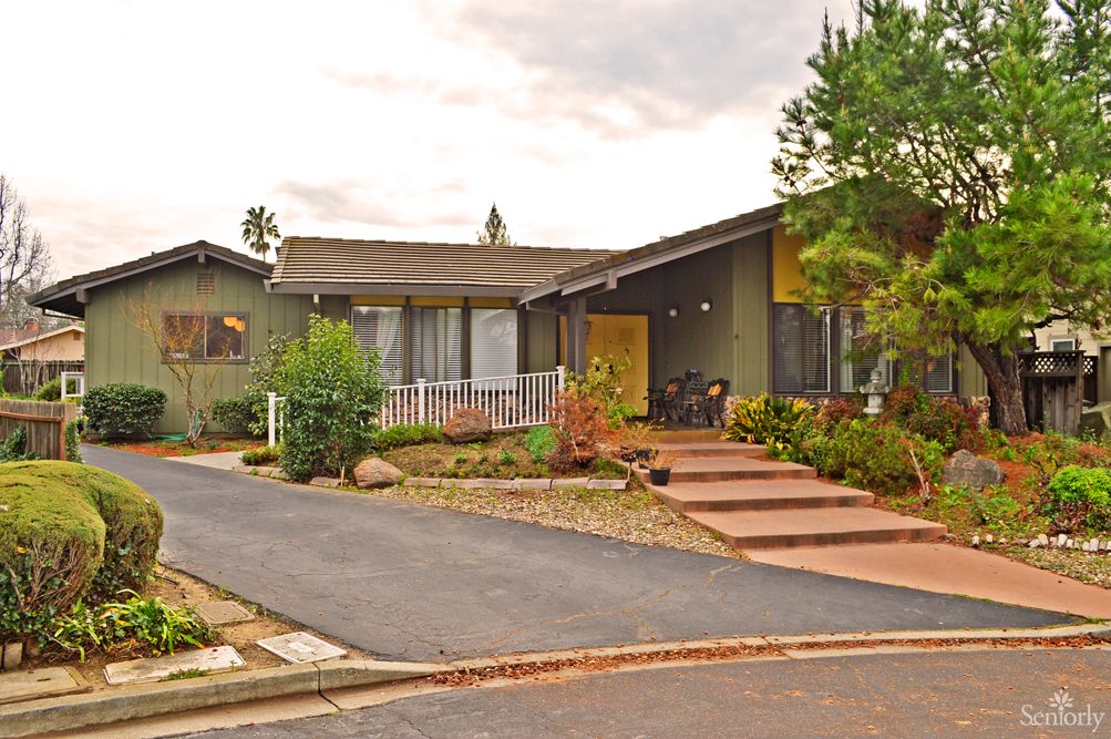 A suburban house with a driveway and well-maintained landscaping.