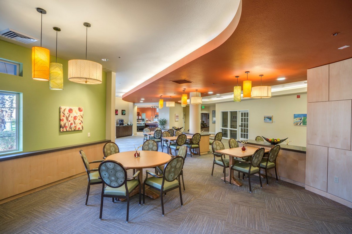 A modern and inviting dining area with tables, chairs, and warm lighting.