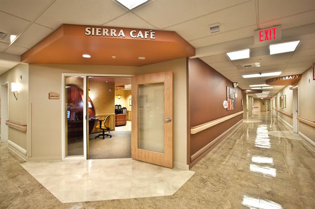 Entrance to a modern cafe in a hallway setting.
