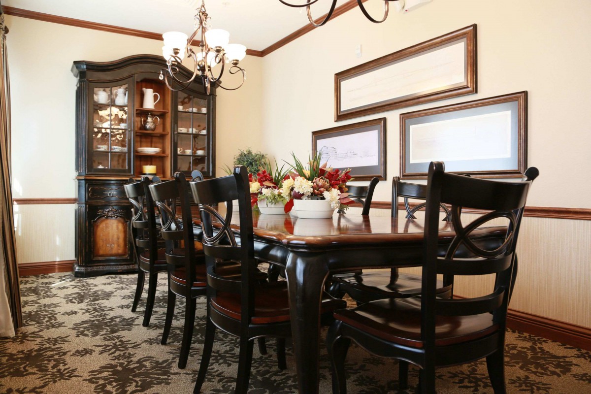 Elegant dining room setup with a large table and ornate chandelier.