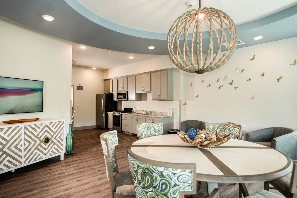 A modern kitchen and dining area with a stylish chandelier and contemporary decor.