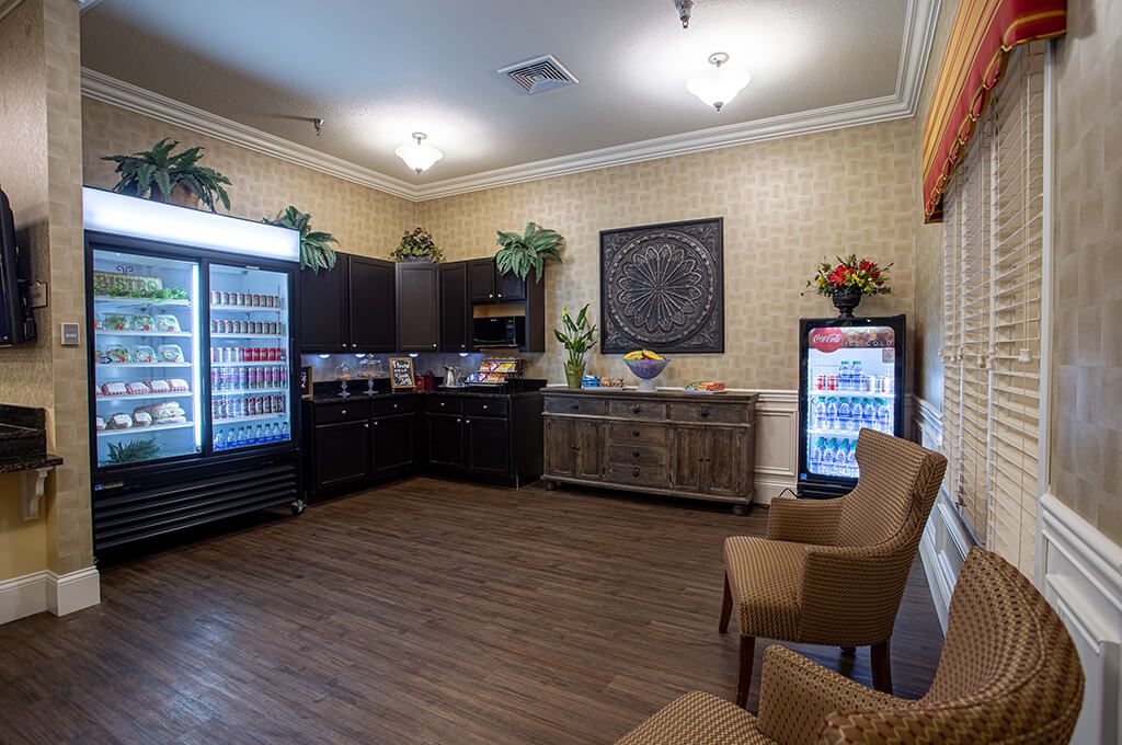 A cozy lounge area with comfortable seating and refreshments available in refrigerators.