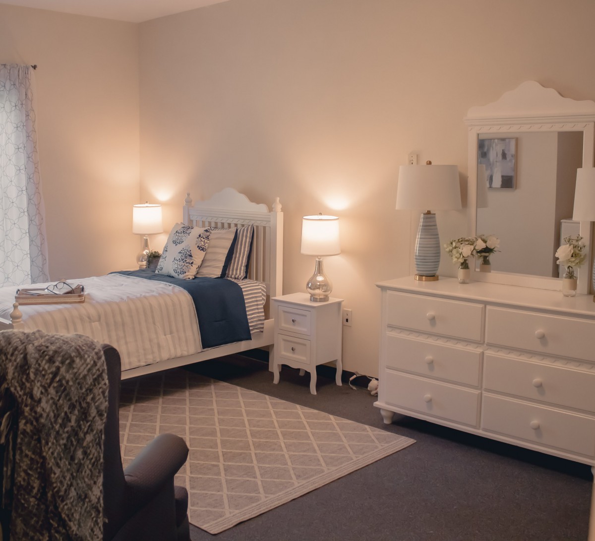 A cozy and elegantly decorated bedroom with soft lighting.