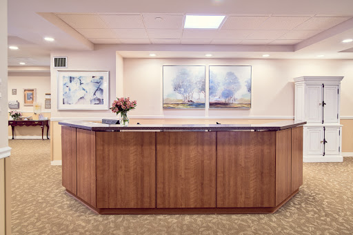 A welcoming reception area featuring a wooden counter and modern artwork.