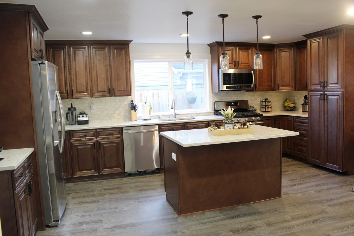 A modern kitchen with wooden cabinets and a central island.