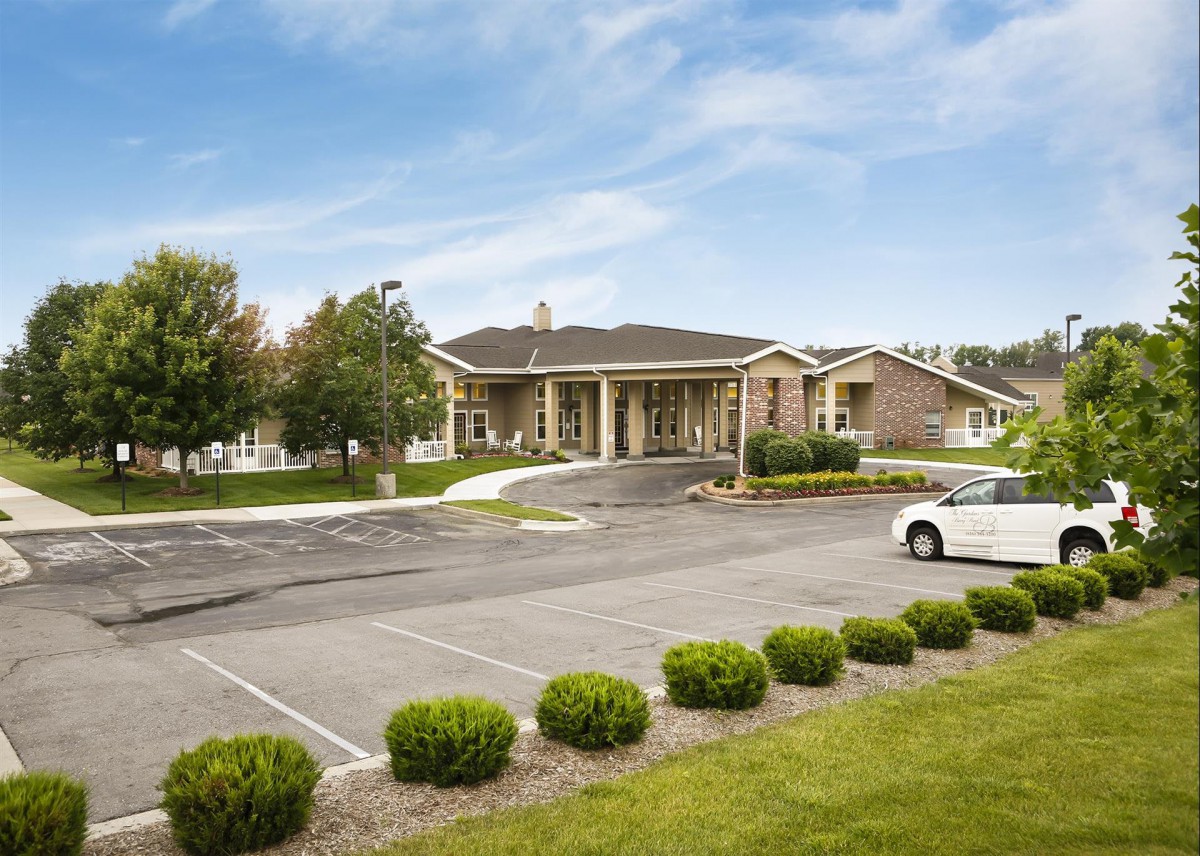 A suburban building with a parking lot and landscaped surroundings.