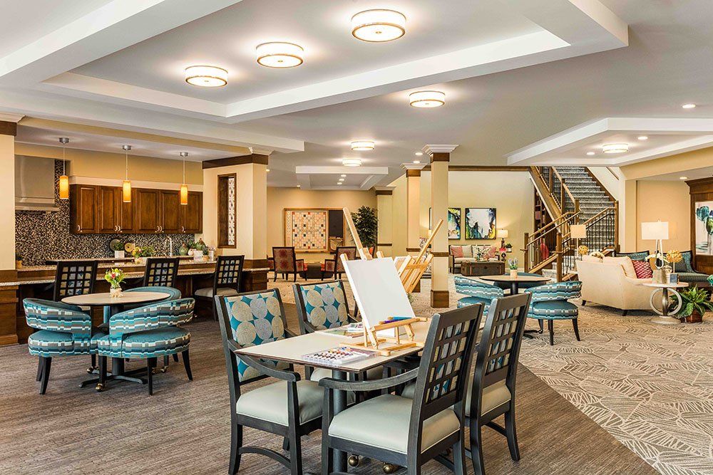 A modern and spacious dining area with elegant furniture and lighting.