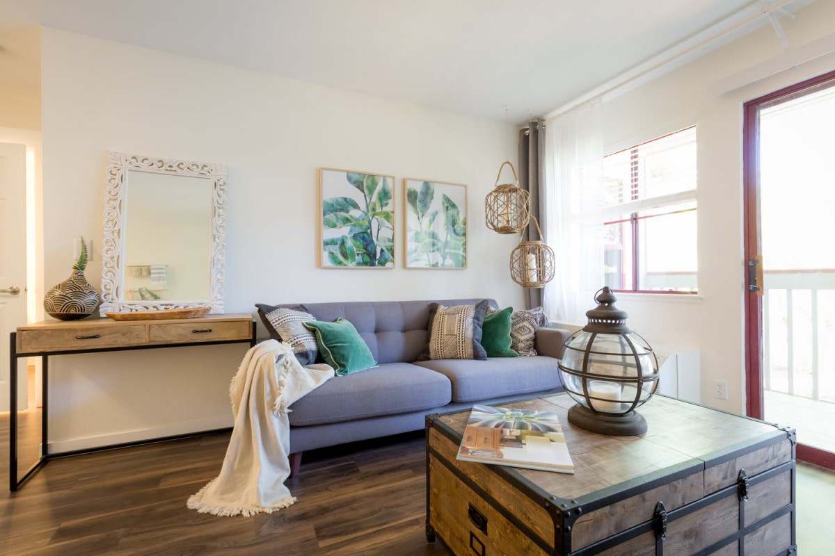 A cozy living room with a comfortable sofa, decorative pillows, and contemporary artwork.