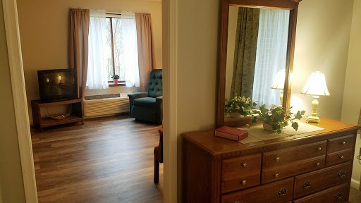 A view of a cozy living space with natural light highlighting the furniture and decor.