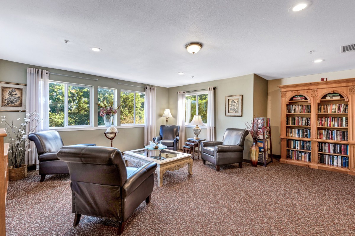 A cozy living room with comfortable seating and a bookshelf.