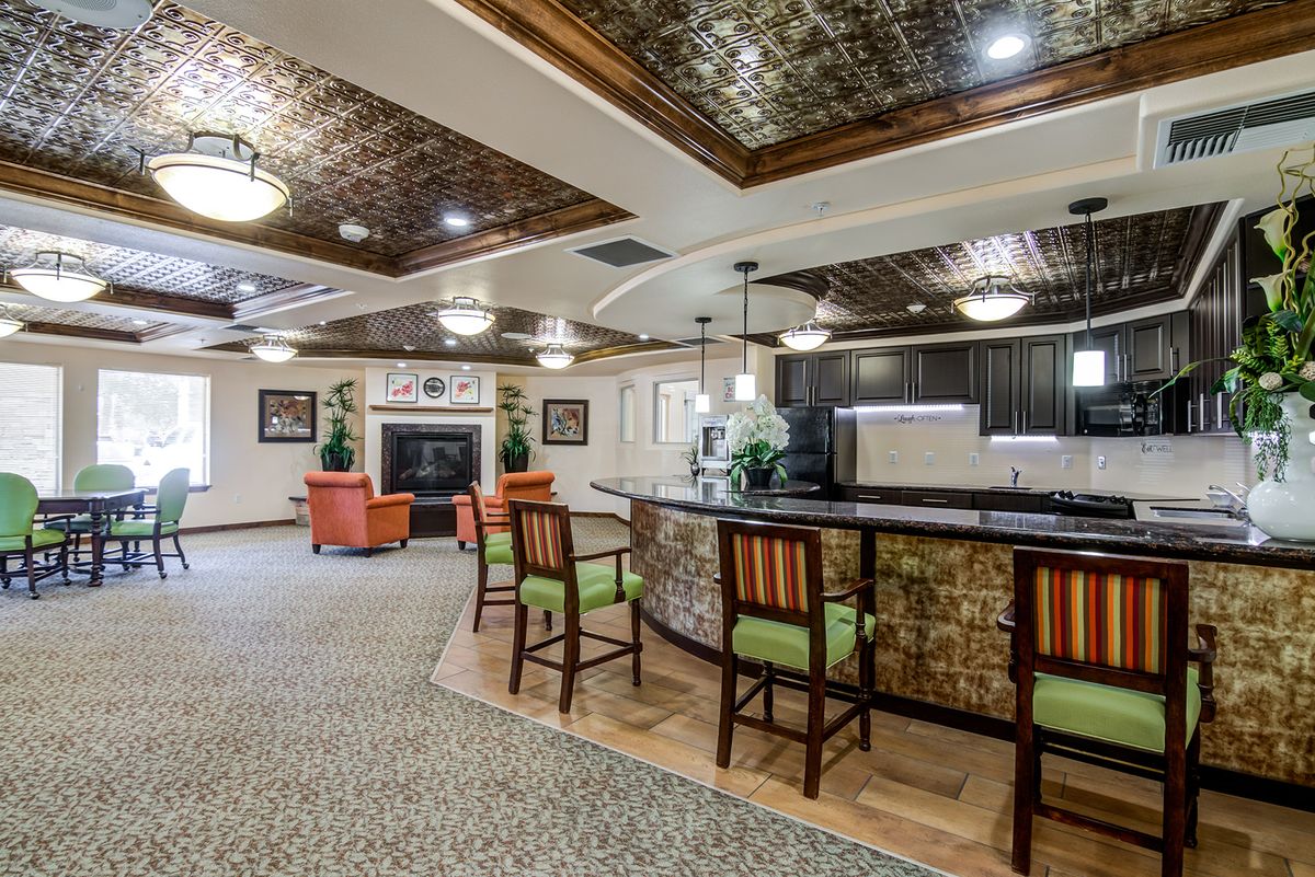 A cozy lounge area with a bar counter, comfortable seating, and elegant decor.