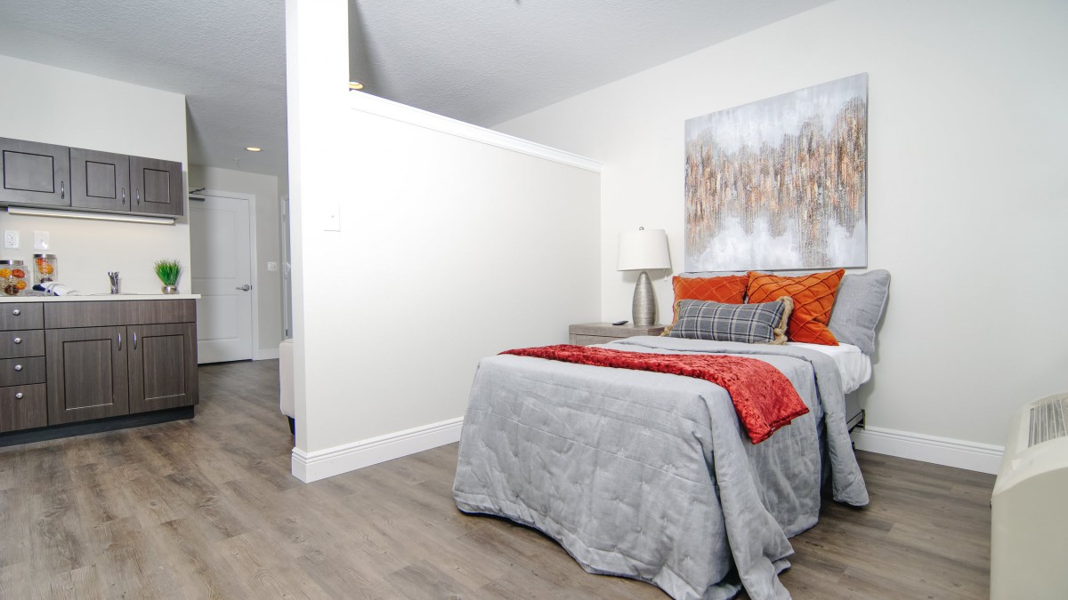 A modern bedroom with stylish decor and a cozy bed.