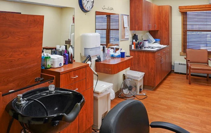 A well-organized hair salon interior with styling chairs, mirrors, and beauty products.