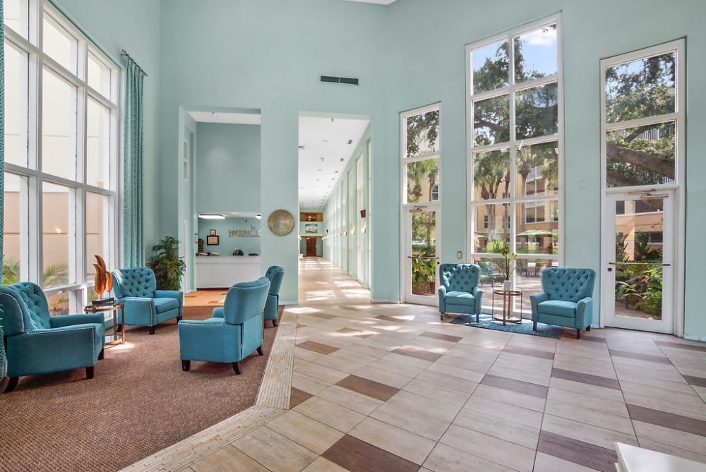 A spacious and modern lobby with large windows and comfortable seating.