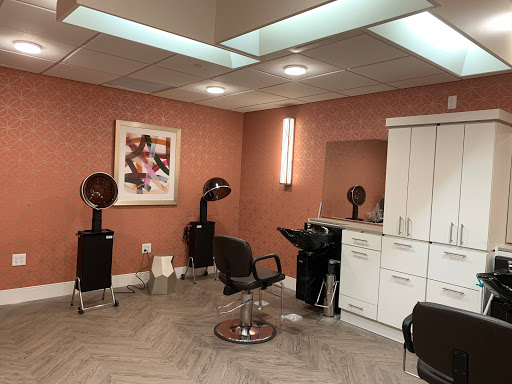 A modern hair salon with stylish furniture and equipment.