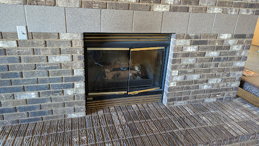 A modern fireplace framed by stylish brickwork, perfect for cozy gatherings.