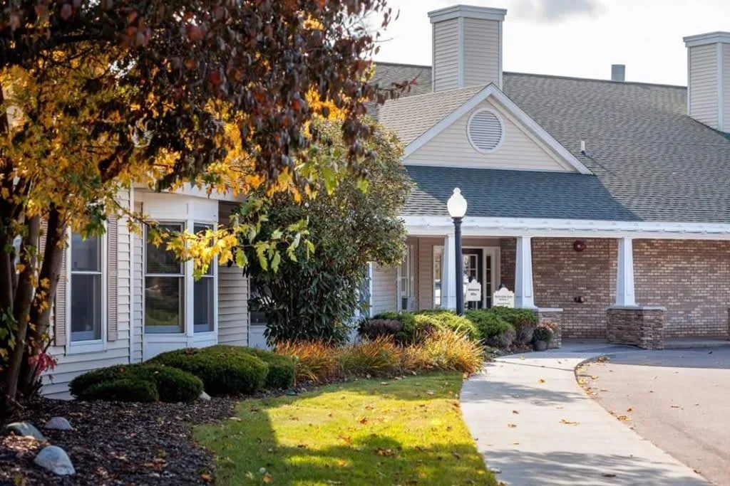 A charming building surrounded by autumn foliage and a winding pathway.