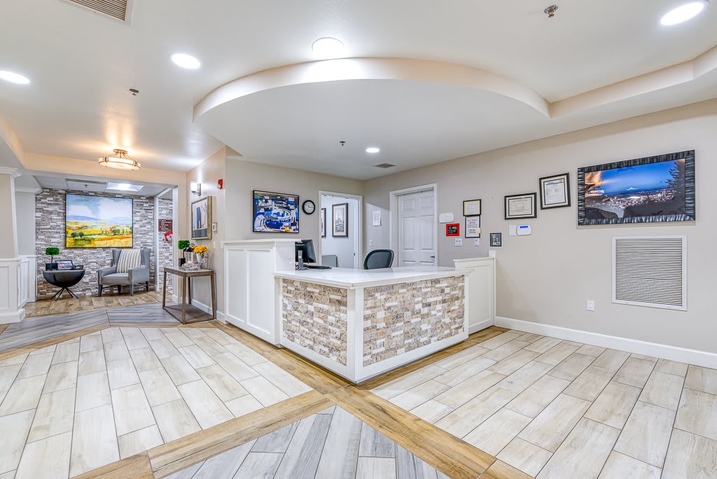 A modern reception desk with decorative elements in a well-lit office interior.