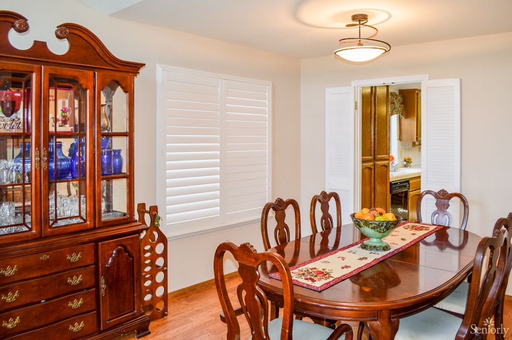 A well-furnished dining room with a wooden table, chairs, and a china cabinet.