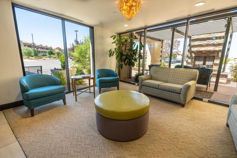 A modern waiting room with comfortable seating and abundant natural light.